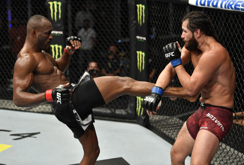 ABU DHABI, UNITED ARAB EMIRATES - JULY 12: In this handout image provided by UFC, (L-R) Kamaru Usman of Nigeria kicks Jorge Masvidal in their UFC welterweight championship fight during the UFC 251 event at Flash Forum on UFC Fight Island on July 12, 2020 on Yas Island, Abu Dhabi, United Arab Emirates. (Photo by Jeff Bottari/Zuffa LLC via Getty Images)