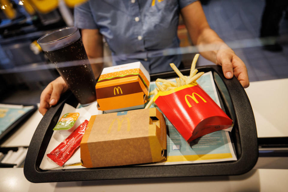 a McDonald's employee handing out a tray