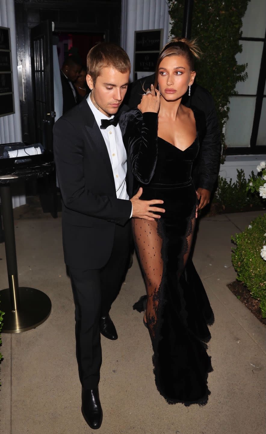 <p>The couple dressed in their best while in West Hollywood to celebrate the opening of Justin's art gallery auction, with Hailey wearing a velvet full-length gown with sheer lace panels, by Alessandra Rich. As they left the venue, Justin placed a protective hand on Hailey's hip as they navigated the awaiting photographers. </p>