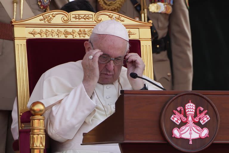 Pope Francis adjusts his glasses, as he attends the closing session of the "Bahrain Forum for Dialogue: East and west for Human Coexistence", at the Al-Fida square at the Sakhir Royal palace, Bahrain, Friday, Nov. 4, 2022. Pope Francis is making the November 3-6 visit to participate in a government-sponsored conference on East-West dialogue and to minister to Bahrain's tiny Catholic community, part of his effort to pursue dialogue with the Muslim world. (AP Photo/Hussein Malla)