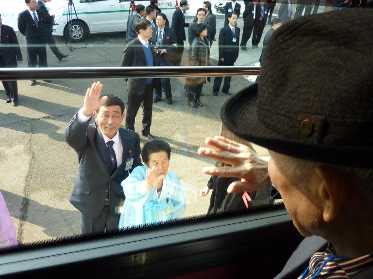 A South Korean waves goodbye from a bus to his North Korean sister and nephew after a family reunion in February 2014