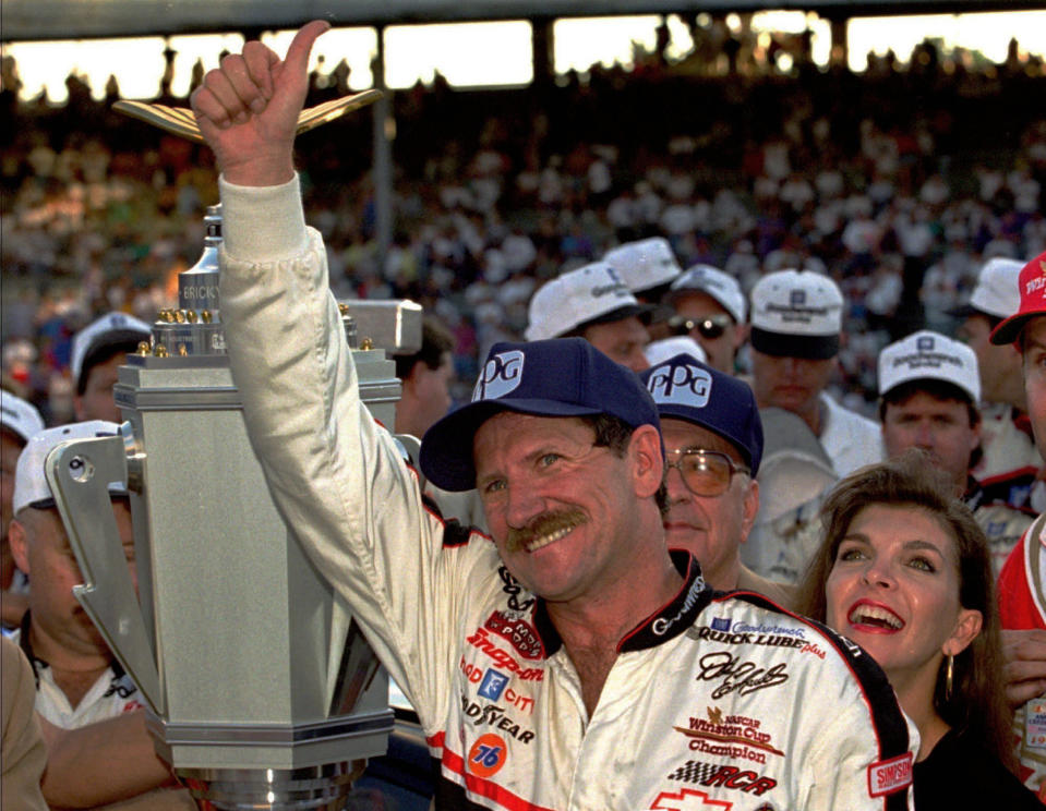 FILE - NASCAR driver Dale Earnhardt of Mooresville, N.C., gestures to the crowd from after winning the Brickyard 500 auto race at Indianapolis Motor Speedway, Saturday, Aug. 5, 1995. To mark NASCAR’s 75th season, The Associated Press interviewed 12 key contributors to the industry on multiple topics. According to the survey, Dale Earnhardt's death in the 2001 Daytona 500 was picked as NASCAR's most pivotal moment. (AP Photo/Tom Strattman, File)