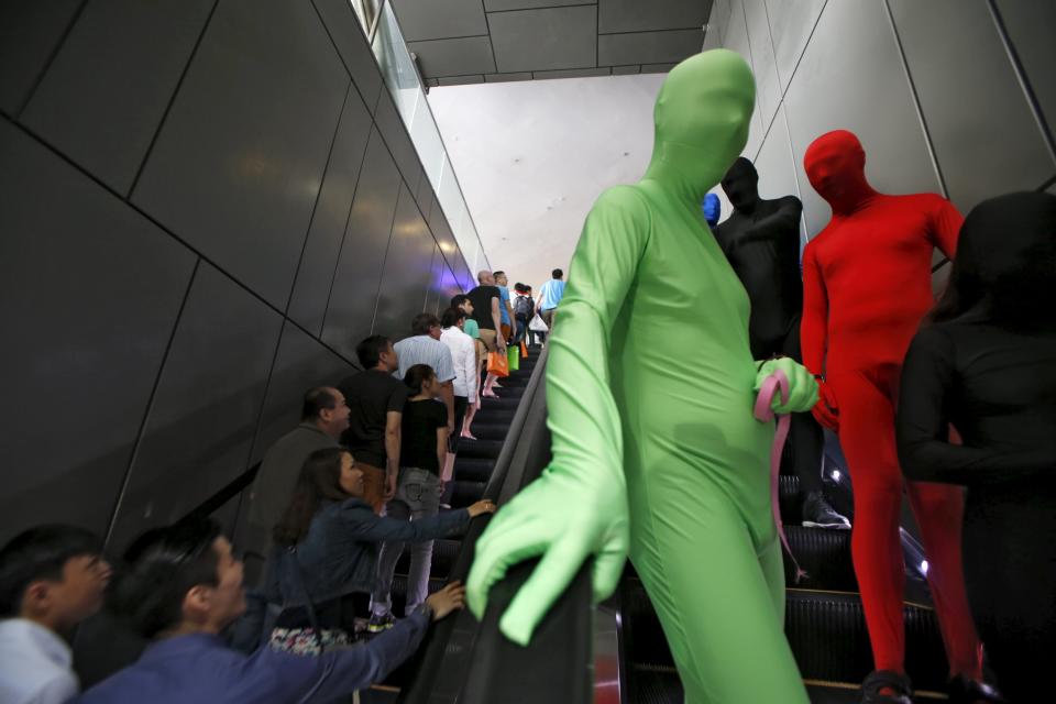 Participants wearing Zentai costumes, or skin-tight bodysuits from head to toe, take part in a march down the shopping district of Orchard Road during Zentai Art Festival in Singapore May 23, 2015. Close to 50 participants strutted down the busy shopping district during the Zentai art festival which is jointly organized by the Japanese embassy. The festival includes performances and discussions on Zentai from May 22 to from June 5. REUTERS/Edgar Su