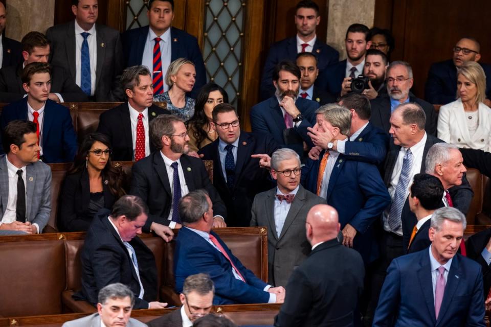 Alabama Rep Mike Rogers is restrained after yelling at Florida’s Matt Gaetz after his repeated refusal to back Kevin McCarthy on 6 January. (EPA)