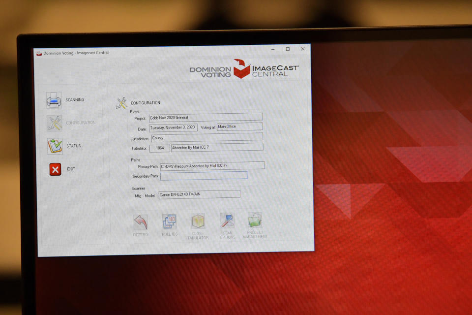 FILE - A monitor showing Dominion Voting Image Cast Central display tab is seen as Cobb County Election officials count ballots on a machine Nov. 24, 2020, in Marietta, Ga. The list of security breaches at local election offices since the 2020 election keeps growing, with investigations ongoing in at least three states, Colorado, Georgia and Michigan. (AP Photo/Mike Stewart, File)