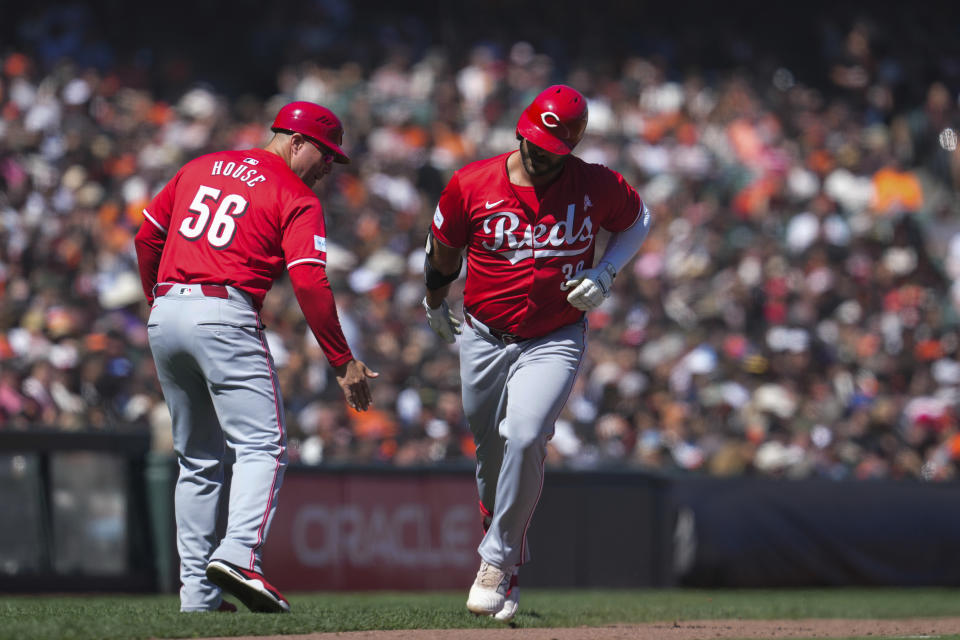 Cincinnati Reds' Mike Ford, right, celebrates with third base coach J.R. House (56) after hitting a solo home run against the San Francisco Giants during the eighth inning of a baseball game Sunday, May 12, 2024, in San Francisco. (AP Photo/Godofredo A. Vásquez)