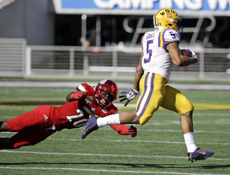 LSU running back Derrius Guice (5) runs past Louisville cornerback Ronald Walker for a 70-yard touchdown during the second half of the Citrus Bowl NCAA college football game, Saturday, Dec. 31, 2016, in Orlando, Fla. LSU won 29-9. (AP Photo/John Raoux)