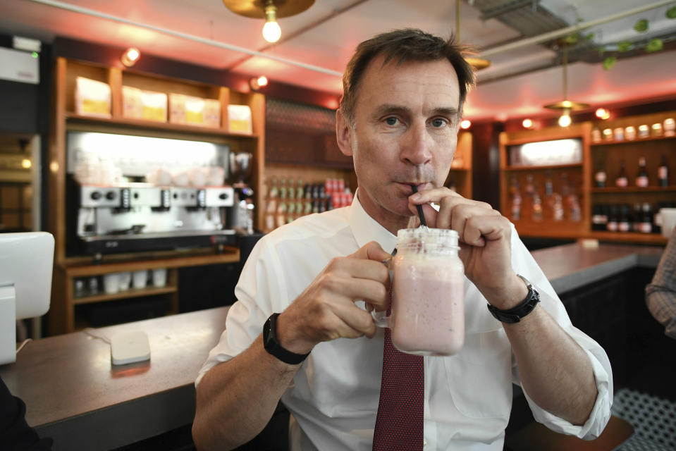 Britain's Conservative party leadership candidate Jeremy Hunt sips a milkshake during a visit to Chelmsford High Street, in Essex, England, Wednesday June 26, 2019. (Stefan Rousseau/PA via AP)