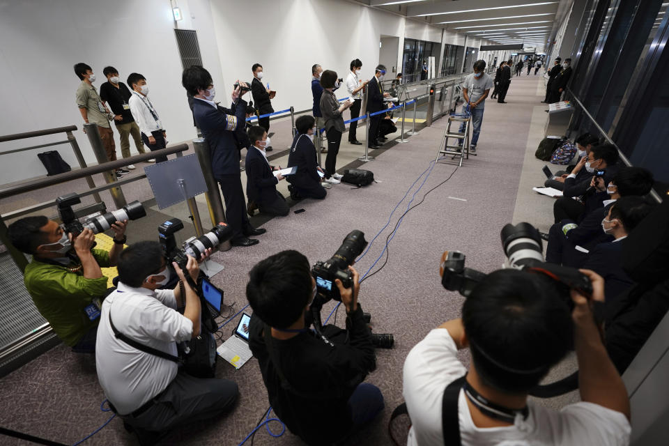 Yuki Kitazumi, a Japanese freelance journalist detained by security forces in Myanmar in mid-April and accused of spreading fake news criticizing the military coup, speaks to media as he arrived at Narita International Airport, in Narita, east of Tokyo. (AP Photo/Eugene Hoshiko)