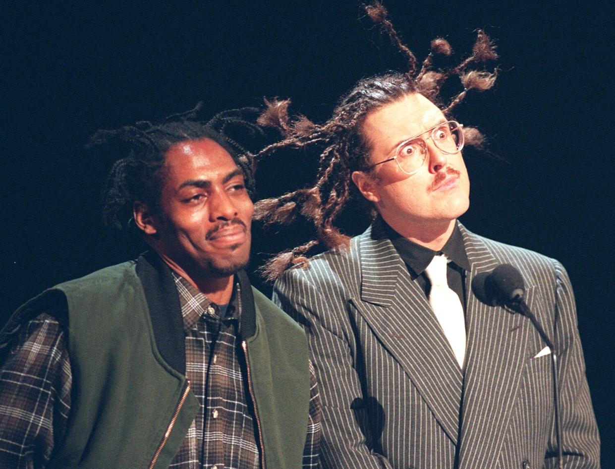 COOLIO YANKOVIC Rap artist Coolio and pop music satirist "Weird Al" Yankovic, with a Coolio hairdo, appear at the podium presenting the favorite alternative artist award to the group Pearl Jam, at the 23rd annual American Music Awards in Los Angeles
