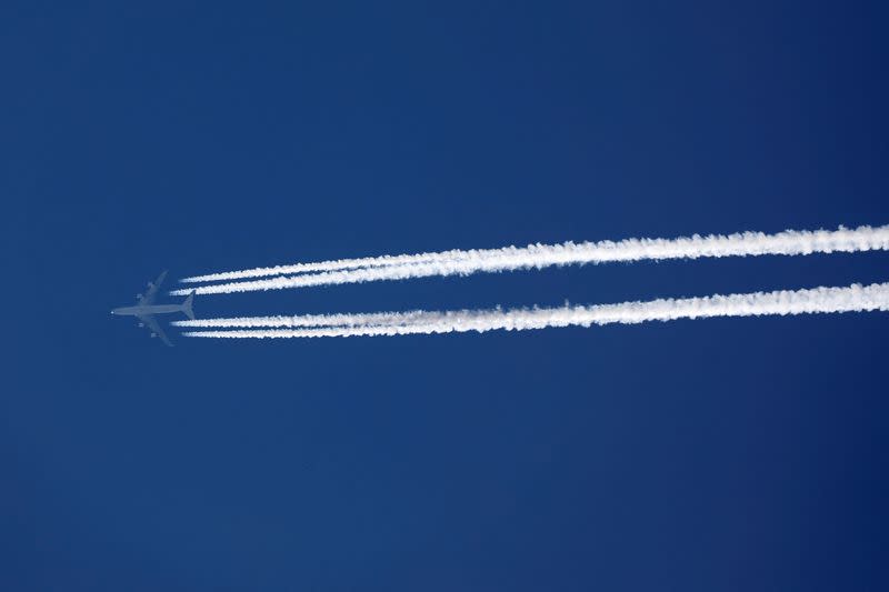 FILE PHOTO: A plane leaves behind contrails as it flies in the sky over Paris