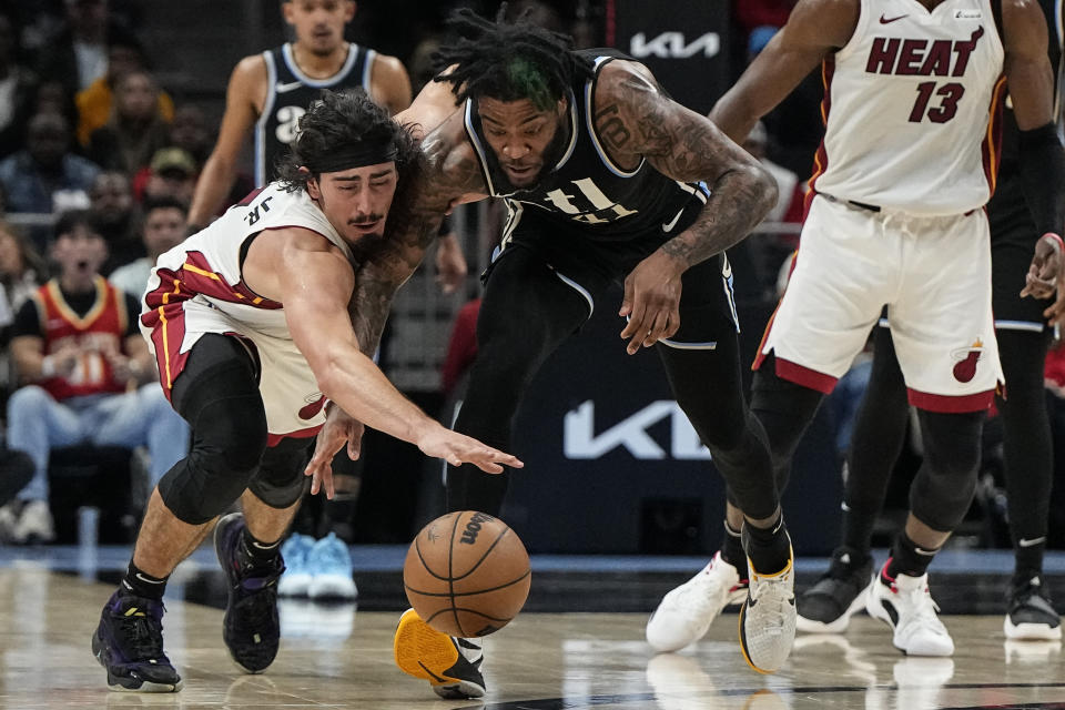 Atlanta Hawks forward Saddiq Bey (41) hits the ball from the hands of Miami Heat guard Jaime Jaquez Jr. (11) during the first half of an NBA basketball game, Saturday, Nov. 11, 2023, in Atlanta. (AP Photo/Mike Stewart)