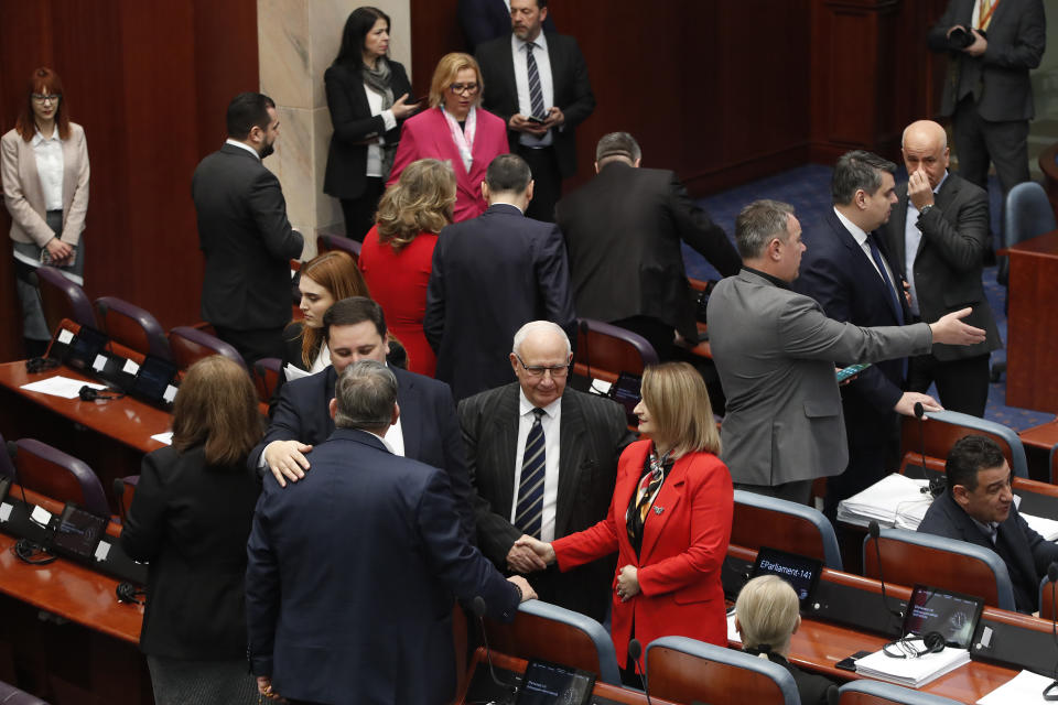 Lawmakers gather for a session of the parliament in Skopje, North Macedonia, on Sunday, Jan. 28, 2024. North Macedonia's parliament has approved on Sunday a new caretaker government installed ahead of general elections this May. (AP Photo/Boris Grdanoski)