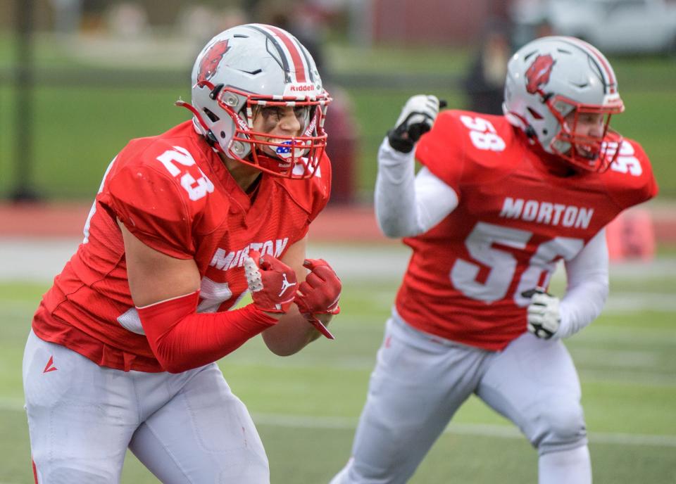 Morton's Brett Michel (23) and Conner Wagner celebrate a Providence turnover in the second half of their Class 5A first-round state football playoff game Saturday, Oct. 28, 2023 in Morton.