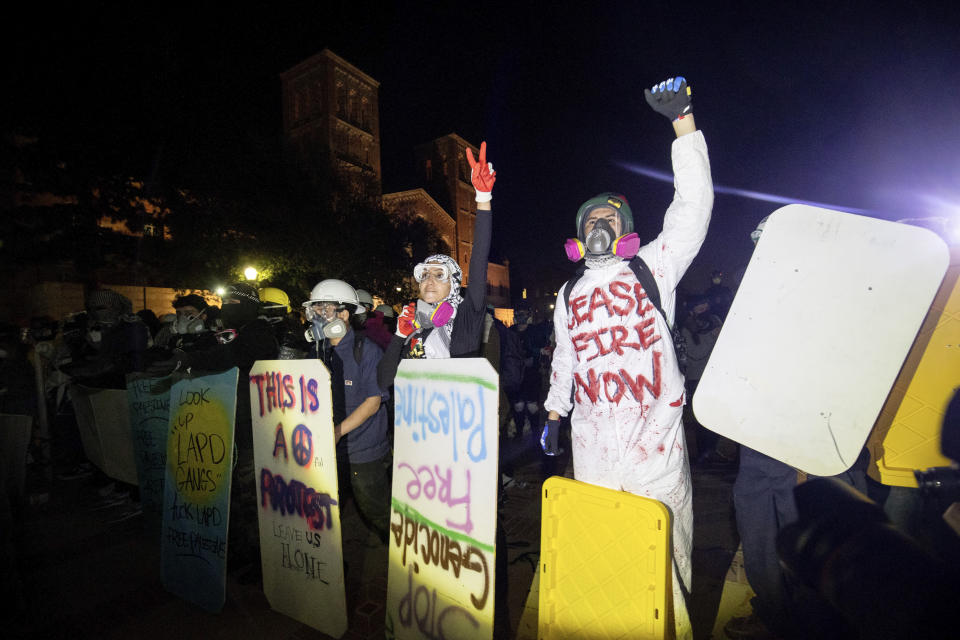 FILE - Demonstrators line up behind makeshift shields as police prepare to advance on them on the UCLA campus, Thursday, May 2, 2024, in Los Angeles. (AP Photo/Ethan Swope, File)