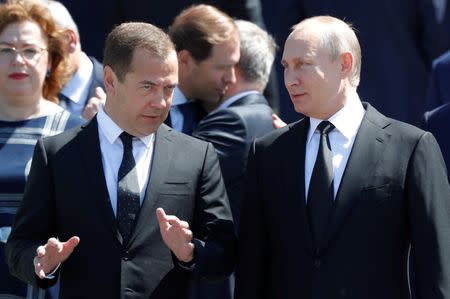 FILE PHOTO: Russian President Vladimir Putin and Prime Minister Dmitry Medvedev attend a wreath laying ceremony marking the anniversary of the Nazi German invasion in 1941, by the Kremlin wall in Moscow, Russia June 22, 2018. REUTERS/Sergei Karpukhin