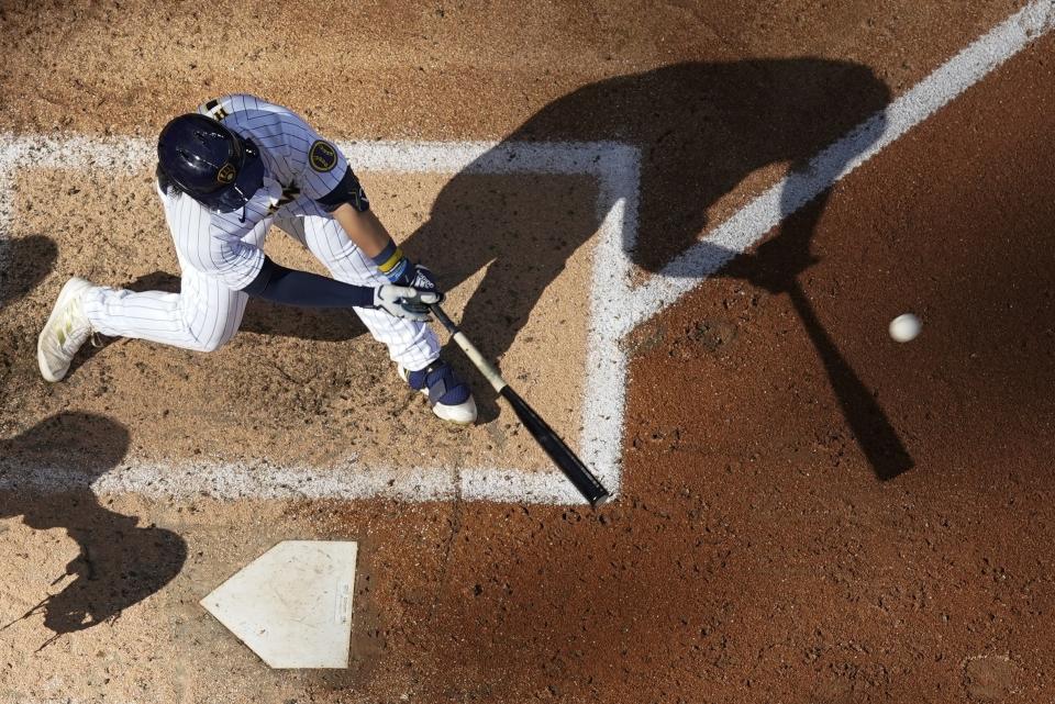 Milwaukee Brewers' Keston Hiura hits an RBI single during the sixth inning of a baseball game against the Pittsburgh Pirates Saturday, July 9, 2022, in Milwaukee. (AP Photo/Morry Gash)