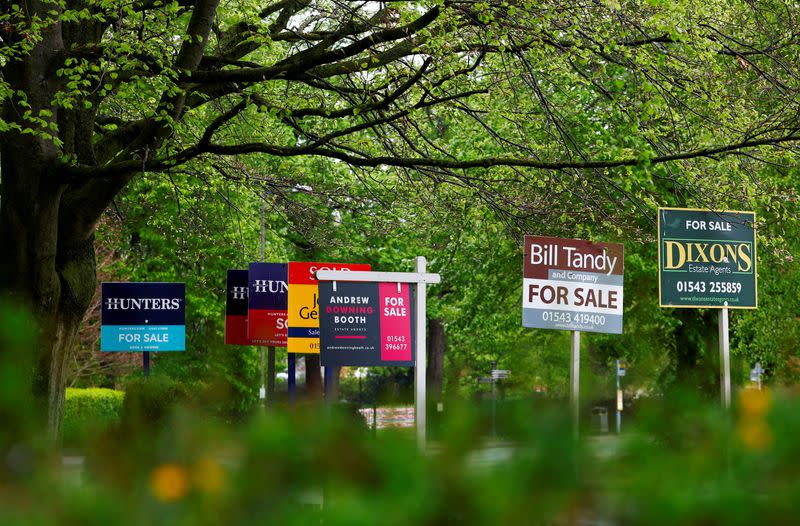 FILE PHOTO: Property estate agent sales and letting signs are seen outside an apartment building