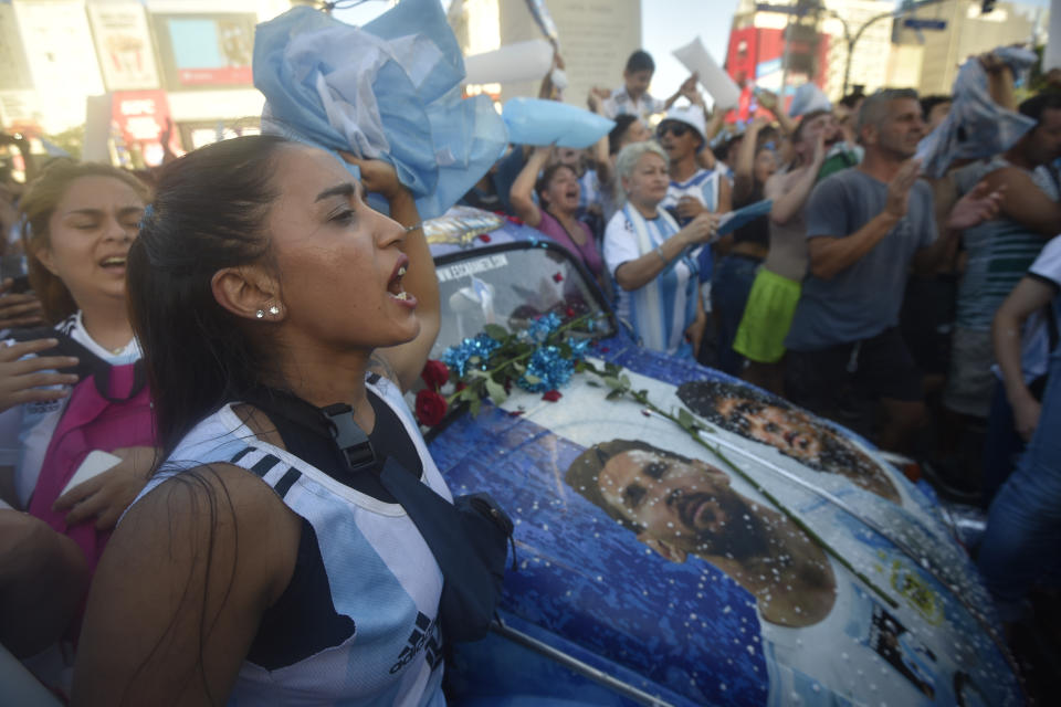 Argentina soccer fans celebrate their team's victory in the semifinals World Cup match against Croatia, hosted by Qatar, at the Obelisk, in Buenos Aires, Argentina, Tuesday, Dec.13, 2022. (AP Photo/Gustavo Garello)