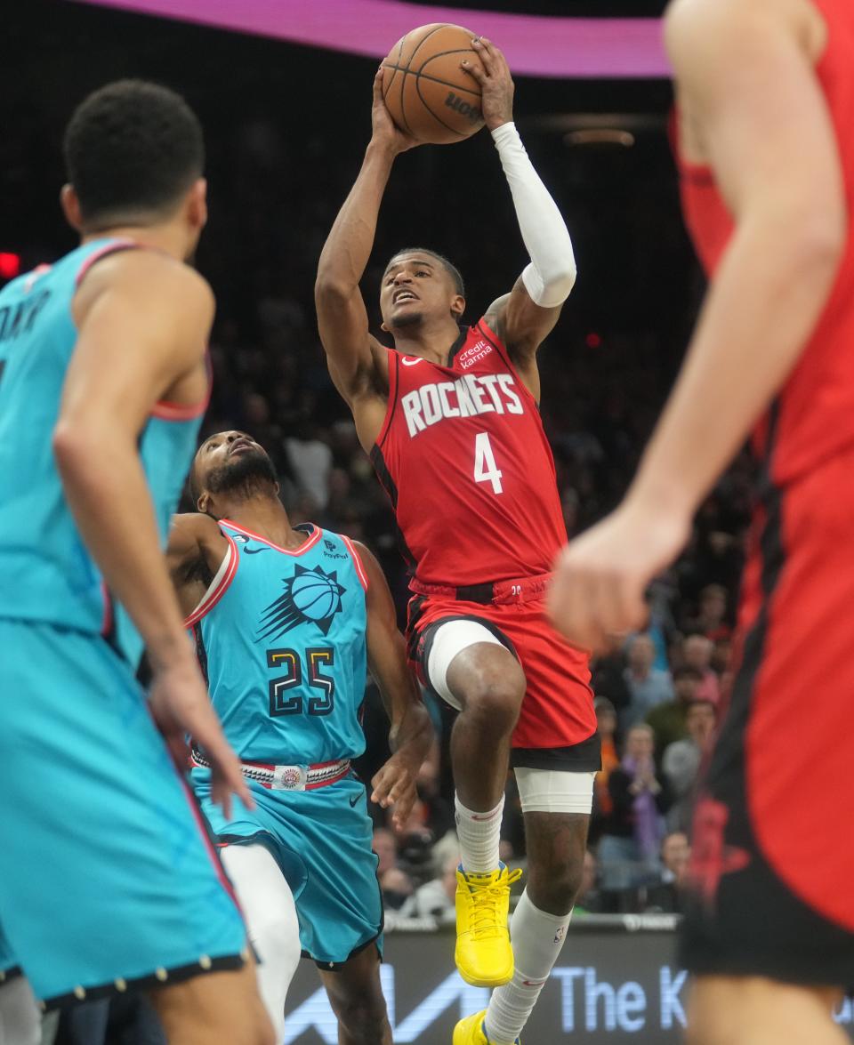 Dec 2, 2022; Phoenix, AZ, USA; Phoenix Suns guard Mikal Bridges (25) fouls Houston Rockets guard Jalen Green (4) as he drives to the basket at Footprint Center. Mandatory Credit: Joe Rondone-Arizona Republic