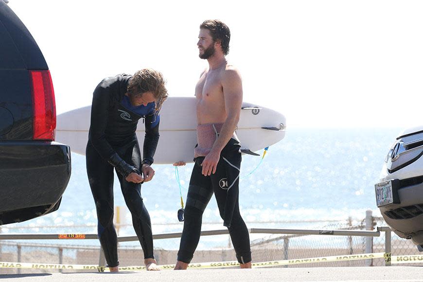 Liam Hemsworth bares all before a day in the surf