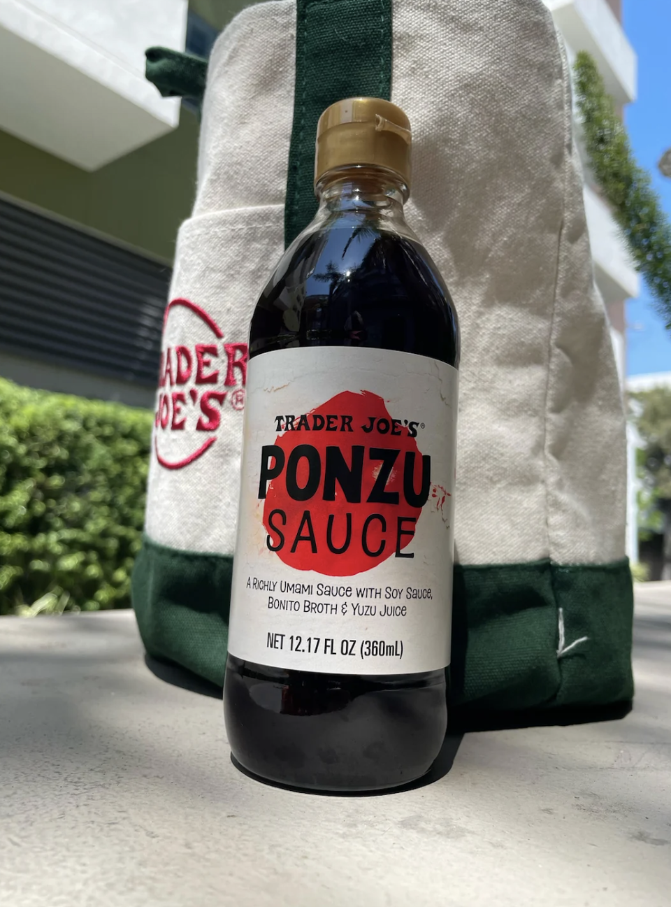 Trader Joe's Ponzu Sauce bottle with product label, net 12.17 fl oz (360ml), placed in front of a Trader Joe's shopping bag