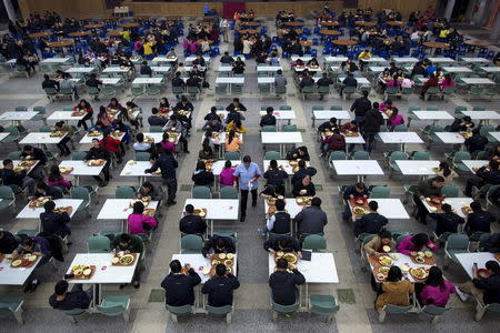 Workers eat their lunch at a restaurant inside a Foxconn factory in the township of Longhua in Shenzhen, Guangdong province, in this January 21, 2015 file photo. REUTERS/Tyrone Siu/Files