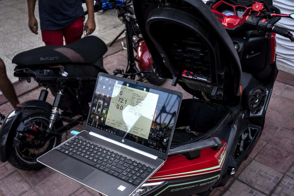 A laptop reads the voltage of an electric scooter after it was used at a gathering in the capital for stunts and races in Cojimar, Cuba, Friday, July 15, 2022. Cuba has been flooded in recent years with “motorinas”, as these electric scooters are called on the island, a fad for many, but also a solution to the transportation problems and fuel shortages that overwhelm the Caribbean nation. (AP Photo/Ramon Espinosa)