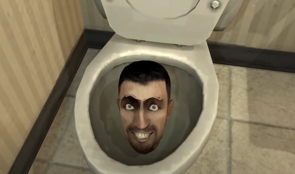 A cartoonish, grinning man's head appears inside a toilet bowl in a bathroom setting