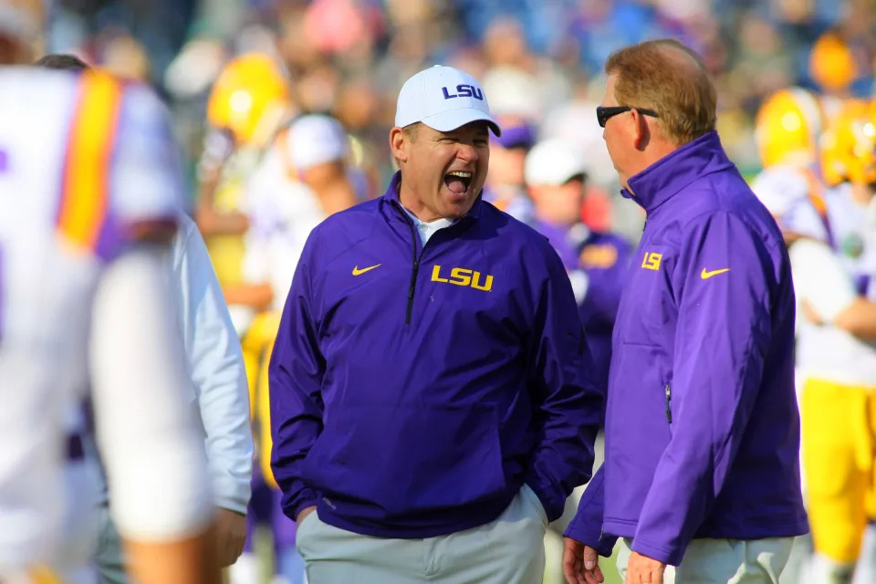 Former LSU Tigers coach Les Miles talks to an assistant before a game against Notre Dame. (Greg McWilliams/Getty Images)