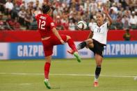 Jul 4, 2015; Edmonton, Alberta, CAN; England defender Lucy Bronze (12) and Germany forward Lena Petermann (19) battle for the ball in the second half during the third place match of the FIFA 2015 Women's World Cup at Commonwealth Stadium. Erich Schlegel-USA TODAY Sports