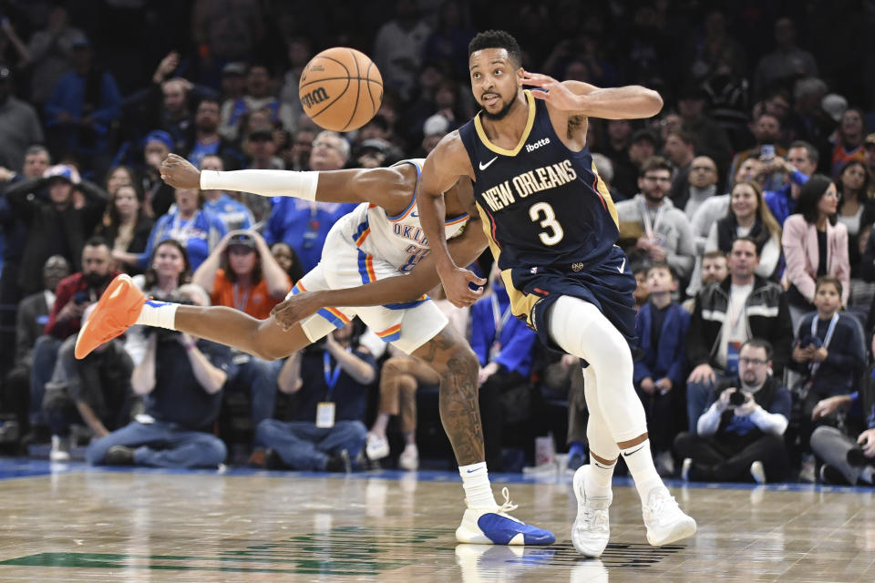 New Orleans Pelicans guard CJ McCollumin, right, pushes past Oklahoma City Thunder forward Jalen Williams, left, the second half of an NBA basketball game, Wednesday, Nov. 1, 2023, in Oklahoma City. (AP Photo/Kyle Phillips)