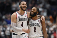 Connecticut's Tyrese Martin and R.J. Cole celebrate after the team's NCAA college basketball game against Villanova, Tuesday, Feb. 22, 2022, in Hartford, Conn. (AP Photo/Jessica Hill)
