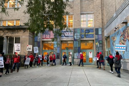 Teachers and parents picket in front of and near Helen C. Pierce School of International Studies during the first day of a teacher strike in Chicago