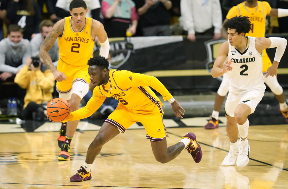 Arizona State guard Jay Heath gathers in the ball in front of forward Jalen Graham, back, and Colorado guard KJ Simpson, right, during the first half of an NCAA college basketball game Thursday, Feb. 24, 2022, in Boulder, Colo. (AP Photo/David Zalubowski)