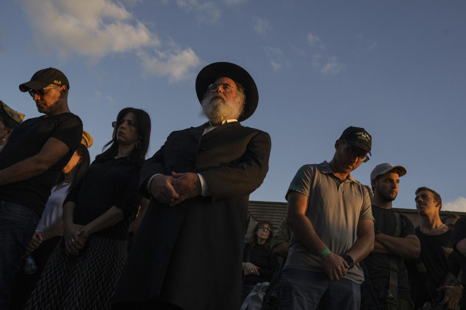 Mourners attend the funeral of the head of the Sha'ar Hanegev Regional Council, Ofir Lipstein, who was killed by Hamas militants at a cemetery at Even Yehuda cemetery , central Israel, Wednesday, Oct. 18, 2023. (AP Photo/Petros Giannakouris