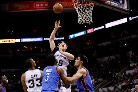 May 21, 2014; San Antonio, TX, USA; San Antonio Spurs forward Aron Baynes (16) shoots the ball over Oklahoma City Thunder forward Perry Jones (3) and center Steven Adams (right) in game two of the Western Conference Finals of the 2014 NBA Playoffs at AT&T Center. Soobum Im-USA TODAY Sports