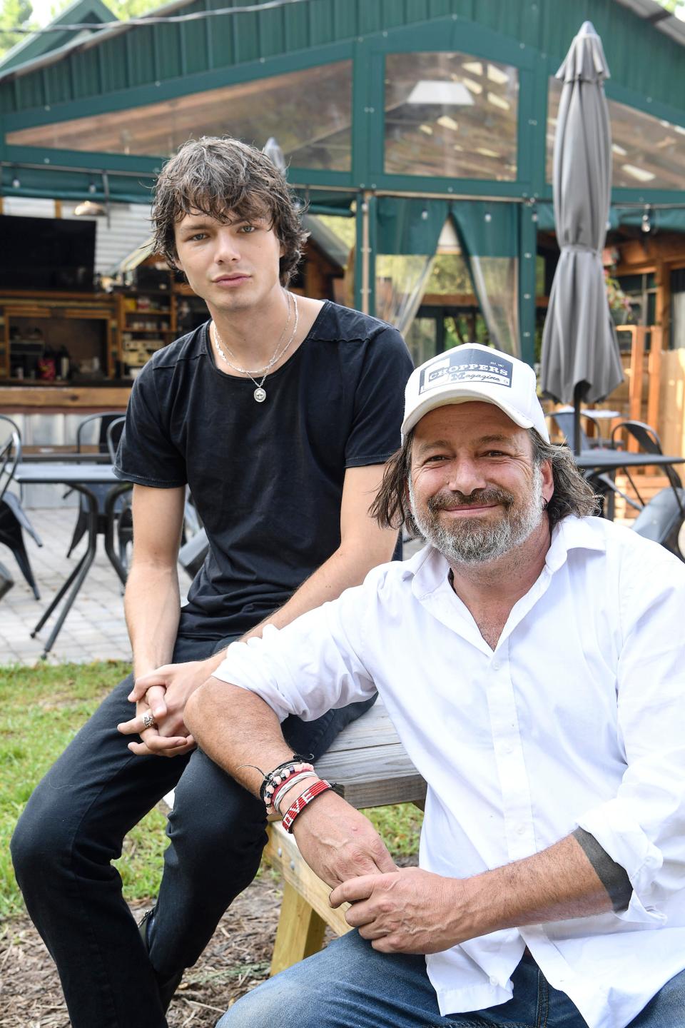 Mark Henegan, chef and co-owner of The Bush Farmhouse in Black Mountain, with his son, Skyler, an artist and manager of the resaurant July 21, 2021.