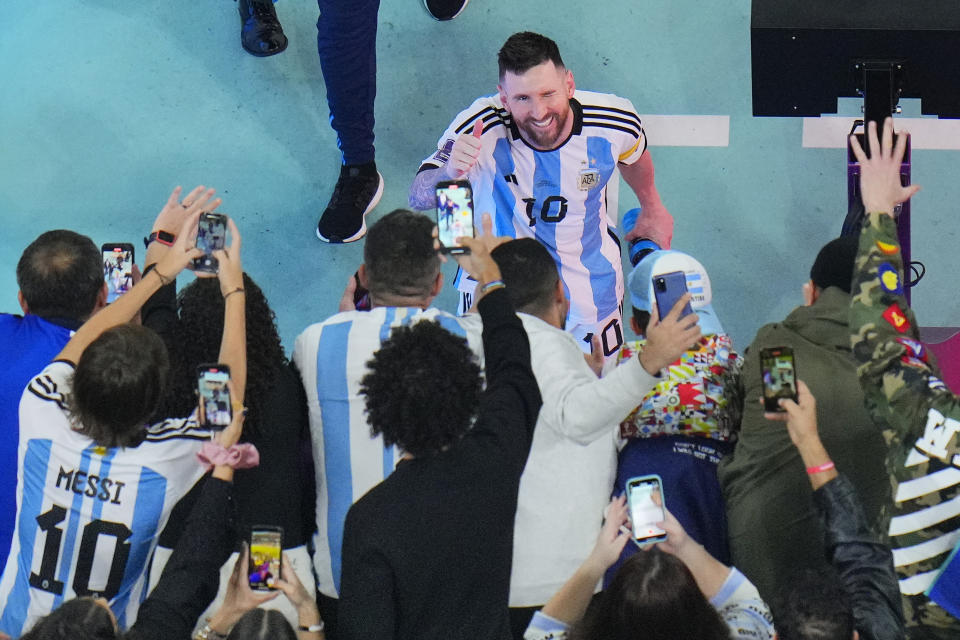 Argentina's Lionel Messi greets cheering fans after his team's 3-0 win in the World Cup semifinal soccer match between Argentina and Croatia at the Lusail Stadium in Lusail, Qatar, Wednesday, Dec. 14, 2022. (AP Photo/Hassan Ammar)