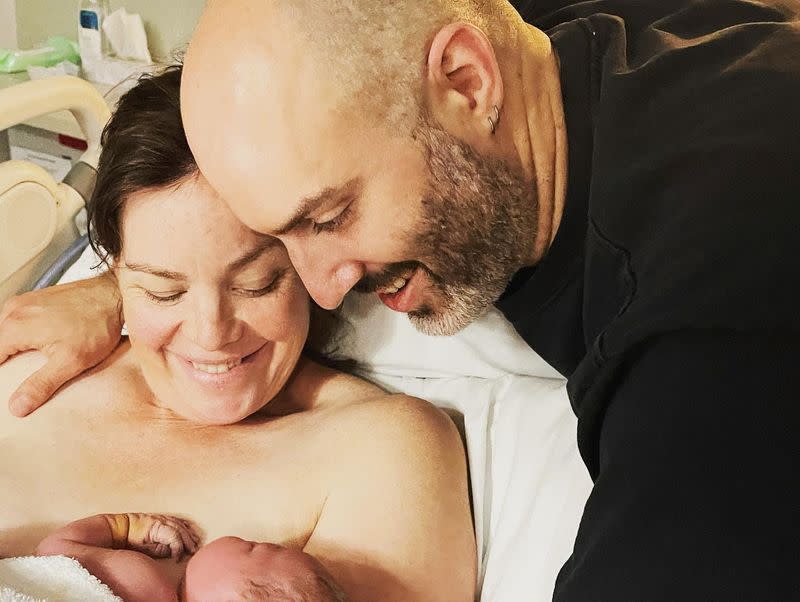 Green Party MP Julie Anne Genter holds her newborn daughter in Wellington