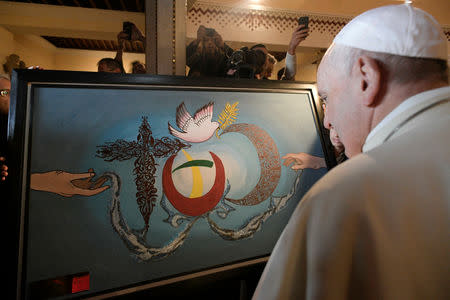Pope Francis looks at a painting during a meeting with representatives of other Christian denominations at Saint Peter's Cathedral in Rabat, Morocco, March 31, 2019. Vatican Media/­Handout via REUTERS