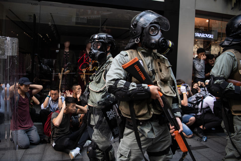 People are detained by riot police during a protest in the Central district of Hong Kong, China, on Wednesday, Nov. 13, 2019. | Laurel Chor/Bloomberg via Getty Images