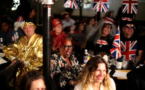 Charlynne Moyer, 60, reacts as she watches a television screen - Credit: LUCY NICHOLSON /Reuters