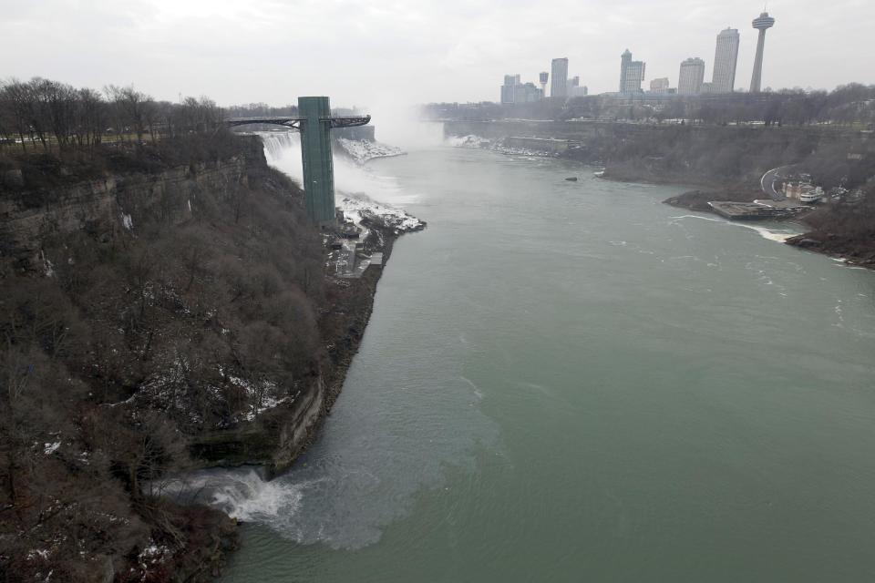 FILE - In this Feb. 17, 2012 file photo, effluent from the Niagara Falls Wastewater Treatment Plant is discharged into the Niagara River near the American Falls in Niagara Falls, N.Y. In recent years, for economic reasons, Niagara Falls has thrown open its doors to casino gambling, gay weddings and a tightrope walk that, until laws were relaxed, would have meant arrest. It even briefly considered taking in toxic wastewater from hydraulic fracturing. On the drawing board now is a plan to entice young people to move in by paying down their student loans. (AP Photo/David Duprey, File)