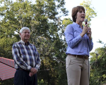 Gwen Graham speaks to supporters with her father, Bob Graham on stage during a rally in Miccosukee, Florida July 31, 2014 in this handout photo provided by Gwen Graham for Congress August 21, 2014. REUTERS/Gwen Graham for Congress/Handout via Reuters