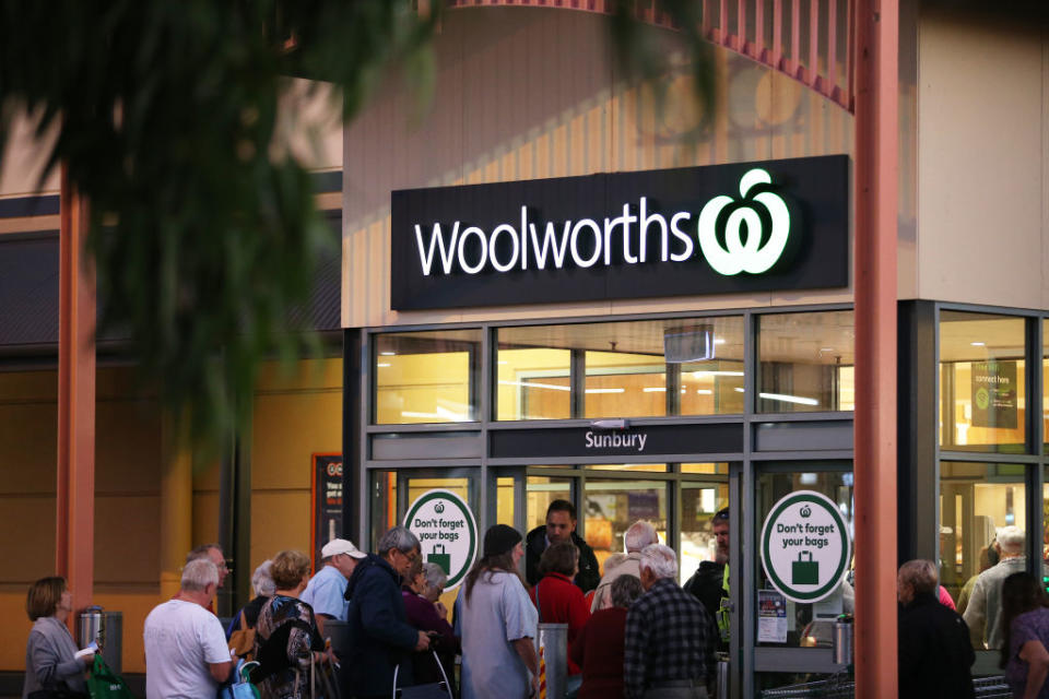 Customers wait outside a Woolworths in Sunbury. Source: Getty