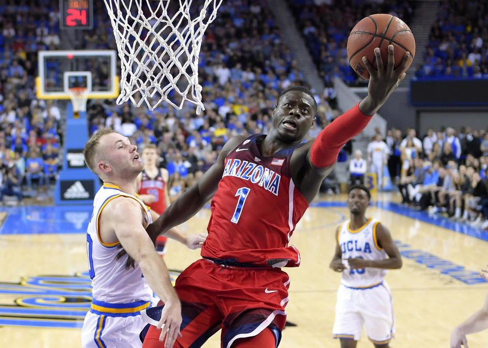 Arizona guard Rawle Alkins, right, shoots as UCLA guard Bryce Alford defends during the second half of an NCAA college basketball game, Saturday, Jan. 21, 2017, in Los Angeles. Arizona won 96-85. (AP Photo/Mark J. Terrill)