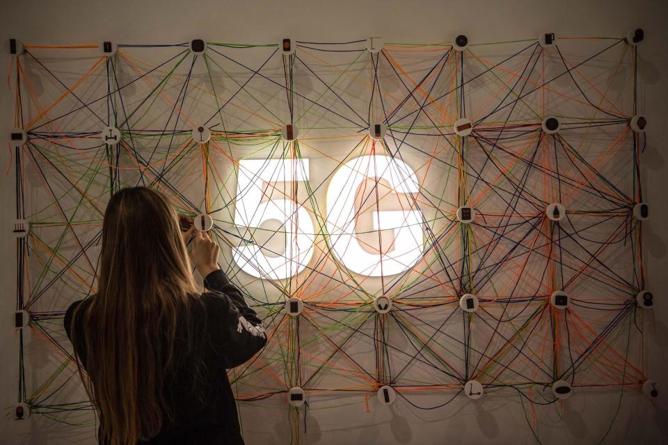 A staff member works next to a 5G logo at the Xiaomi booth on day 2 of the GSMA Mobile World Congress 2019 on February 26, 2019 in Barcelona, Spain: David Ramos/Getty Images