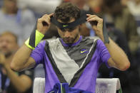 Grigor Dimitrov, of Bulgaria, adjusts his headband during the men's singles semifinals against Daniil Medvedev, of Russia, of the U.S. Open tennis championships Friday, Sept. 6, 2019, in New York. (AP Photo/Charles Krupa)