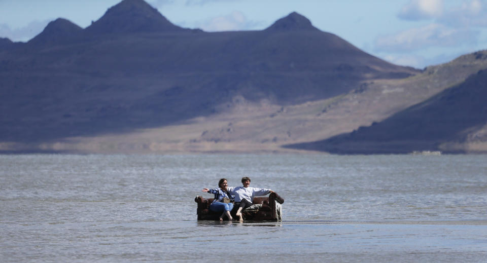 People sit on a couch during a gathering at the Great Salt Lake Saturday, June 8, 2019, near Magna, Utah. Utah park officials invited people to a beach on the lake's south end in an attempt to set the world record for the largest number of people floating together, unassisted, in a line at one time. Utah State Parks manager Jim Wells said only about 300 people showed up for the event. According to the Guinness World Records website , Argentina holds the current record after 1,941 people successfully floated together on the surface of Lago Epecuén de Carhué in 2017. (AP Photo/Rick Bowmer)